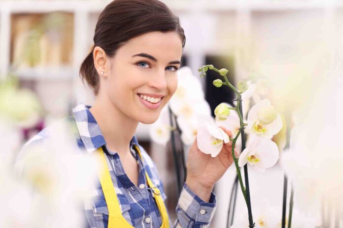 florist woman smiling with flowers orchids florist woman smiling with flowers orchids