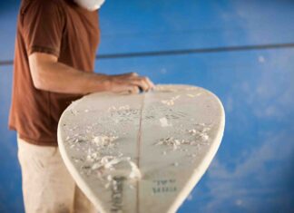 How to promote your product on YouTube man in the process of constructing a surfboard