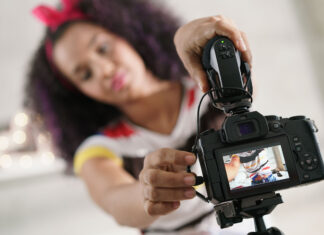 How vlogging has evolved in the past year Woman adjusting a camera to record a vlog