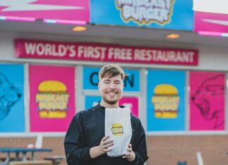 MrBeast files lawsuit against company handling MrBeast Burger MrBeast posing in front of MrBeast Burger