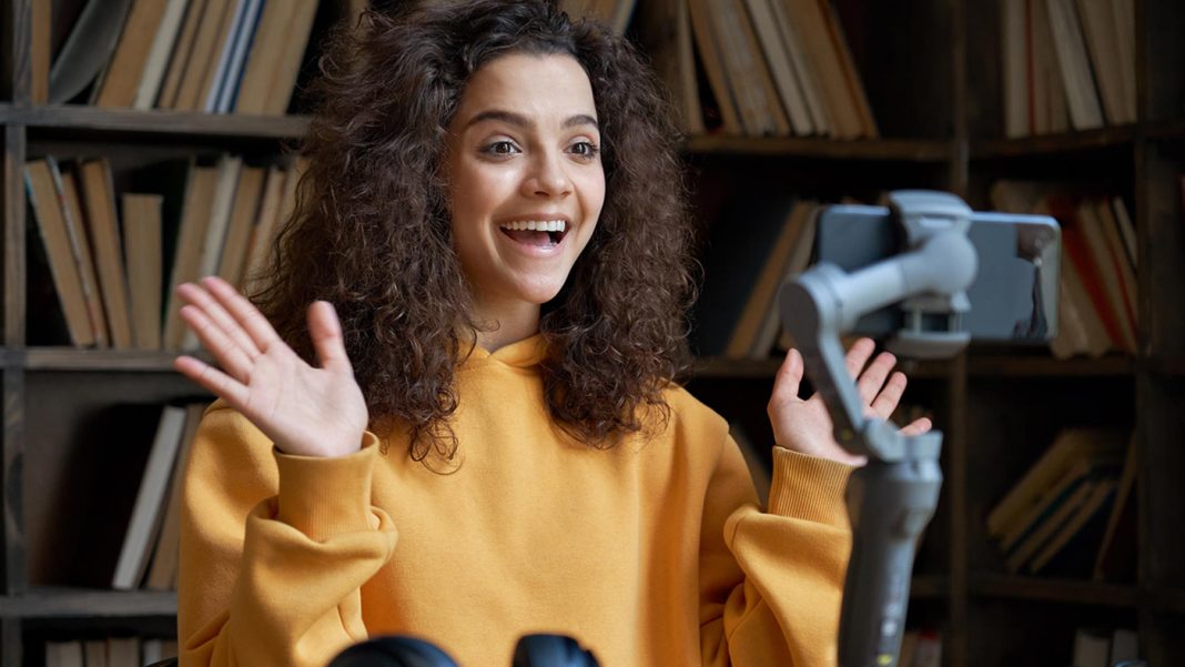 excited-hispanic-teen-girl-social-media-blogger-re-R7VBABV